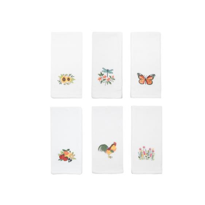 Set of six white napkins with embroidered designs on a white background