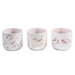 Three ceramic cups with floral and bird designs on a white background