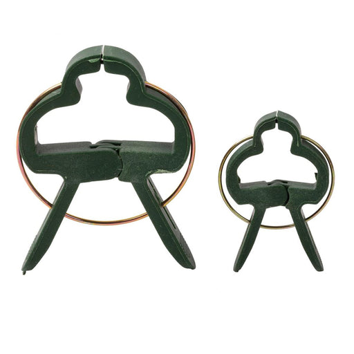 Two green plastic tools with circular ends on a white background