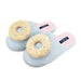 Pair of light blue slippers with donut design on a white background