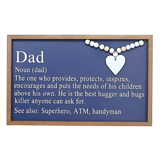 Framed navy wall sign with the definition of “Dad,” featuring white lettering, wood bead detail, and a white heart accent.