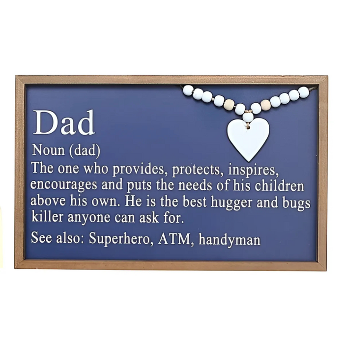 Framed navy wall sign with the definition of “Dad,” featuring white lettering, wood bead detail, and a white heart accent.