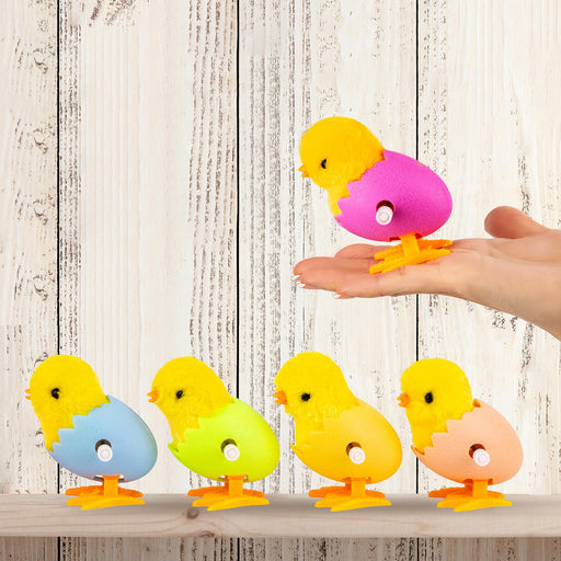 Colorful rubber ducklings on a wooden surface with a hand lifting one out.