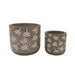 Two ceramic planters with white floral patterns on a white background