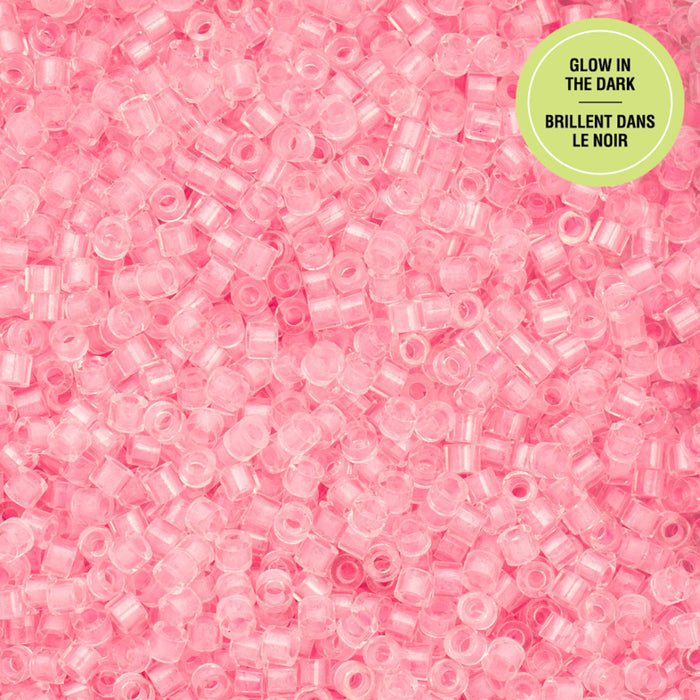 Pink glow-in-the-dark beads on a pink background with a green label.