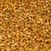 Close-up of a pile of small gold beads