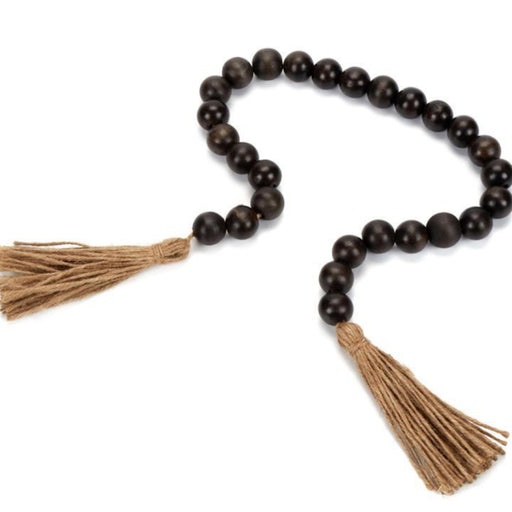 Wooden beaded necklace with tassels on a white background
