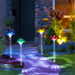 Colorful mushroom-shaped garden lights casting shadows on a pathway.