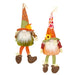 Two autumn-themed fabric gnome decorations standing side by side on a plain white background. One gnome wears an orange and green outfit with a plaid hat, and the other wears an orange and red outfit with a floral hat.
