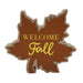 A decorative autumn leaf-shaped sign with a brown center, natural wood edges, and the words 'WELCOME Fall' in gold lettering, shown on a plain white background.