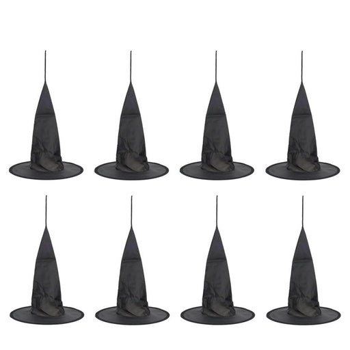 Set of eight black witch hats on a white background
