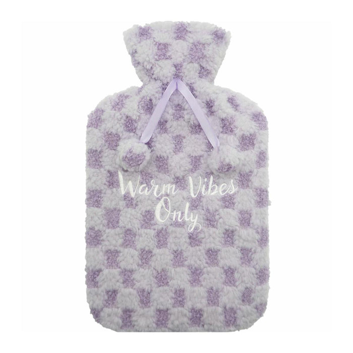 A fluffy hot water bottle cover in a lavender and white checkered pattern, featuring a lavender ribbon at the neck and the text 'Warm Vibes Only' printed in white script on the front.