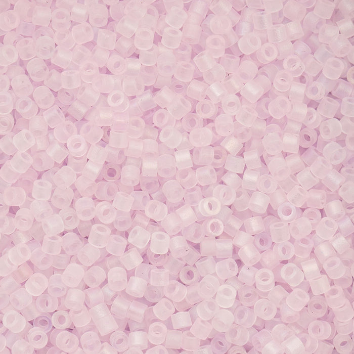 Close-up of light pink beads on a pink background