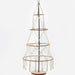 A tiered macrame tree stand with a black central pole, natural wood rings, and cream-colored cord fringe, displayed on a light wood base against a white background.
