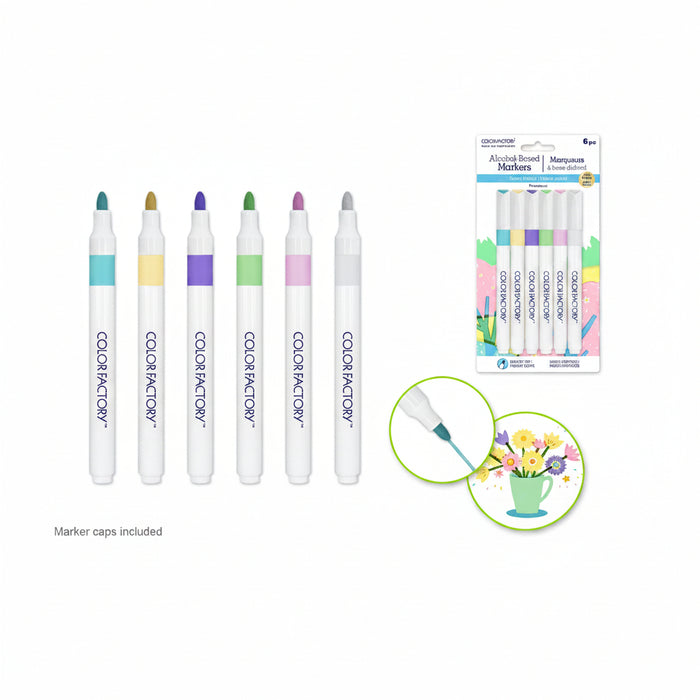 Six Color Factory alcohol-free markers in assorted colors shown upright, with a retail package of six markers on the right and a small usage inset showing a marker tip on flowers. Marker caps are included.