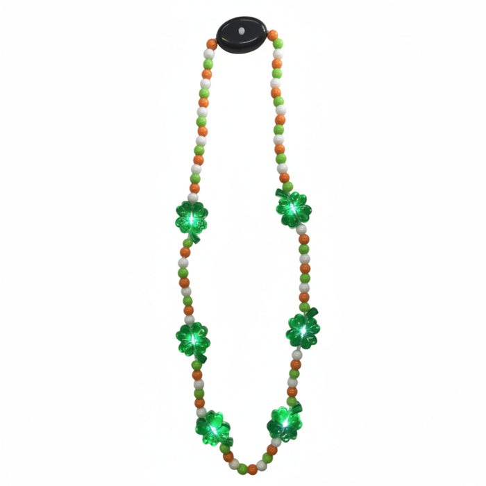 A beaded necklace with green and orange beads and a black pendant featuring a four leaf clover design. The beads are adorned with small green LED lights.