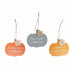 Three autumn-themed wooden hanging ornaments shaped like pumpkins, each with a natural jute hanging string and a small leaf accent. The left ornament is orange and reads 'Autumn leaves & pumpkins please.