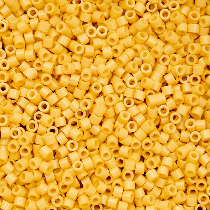 Close-up of yellow plastic beads with holes