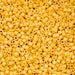 Close-up of yellow plastic beads with holes
