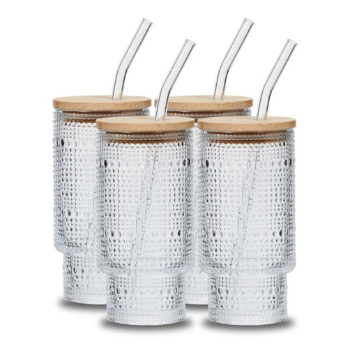 Four silver textured tumblers with wooden lids and clear straws on a white background