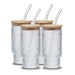 Four silver textured tumblers with wooden lids and clear straws on a white background