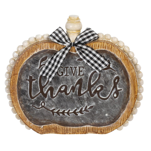 A decorative pumpkin-shaped sign with a faux chalkboard center reading “GIVE thanks,” a wooden-look border, a bead-like edge, and a black-and-white gingham bow at the top, shown on a white background.