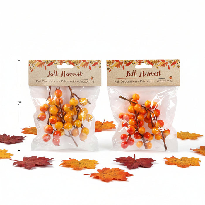 Two clear plastic bags of artificial fall berry branches with brown stems and orange, yellow, and red berries, each with a kraft paper header card reading 'Fall Harvest.' A black height marker on the left indicates 7 inches.