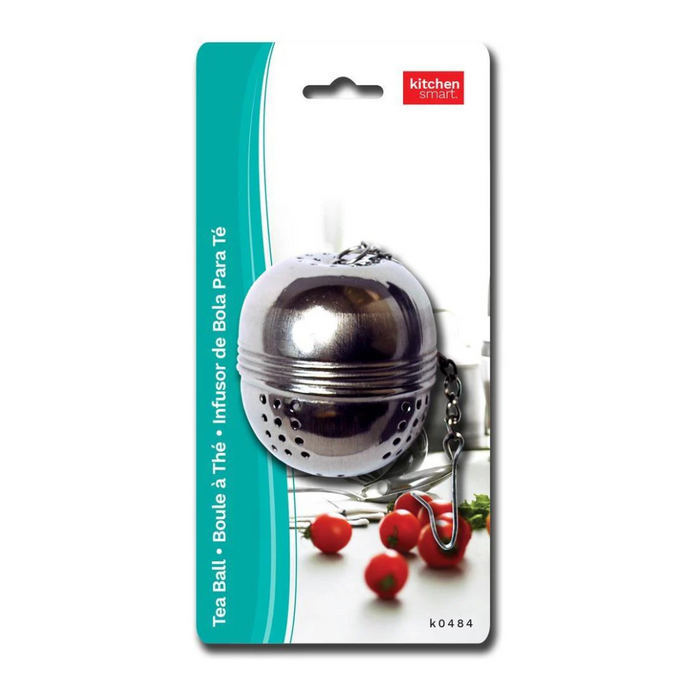 Stainless steel tea ball on packaging with tomatoes in the background