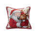 A square decorative throw pillow featuring a needlepoint-style design of Santa Claus hugging a reindeer, with a red patterned border on a white background.