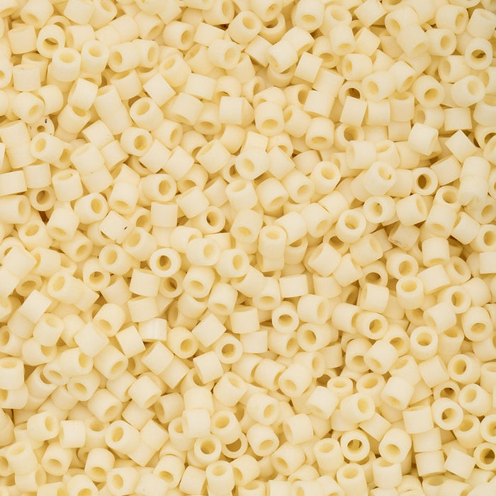 Close-up of a pile of small, round, beige CYLING BEADS. 