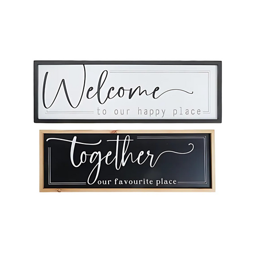 Two assorted framed wooden signs—one white with the phrase “Welcome to our happy place” in black text, and one black with the phrase “Together our favourite place” in white text.