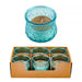 Set of six teal glass candles in a cardboard box with one candle displayed above.