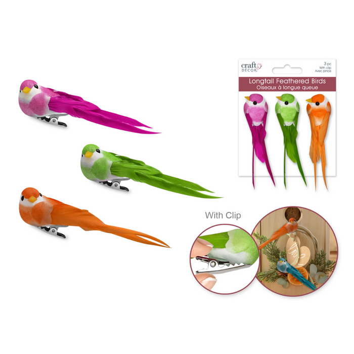 Three mini longtail birds in vibrant pink, green, and orange, each with realistic feathered detailing and a gator clip attached. Includes retail packaging and close-up inset of the clip and a bird used in rustic décor.