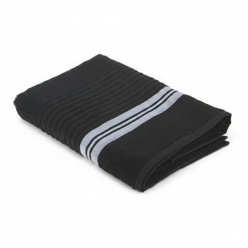 A folded black bath towel with a textured ribbed pattern and two horizontal white stripes near one end, shown on a plain white background.