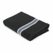 A folded black bath towel with a textured ribbed pattern and two horizontal white stripes near one end, shown on a plain white background.