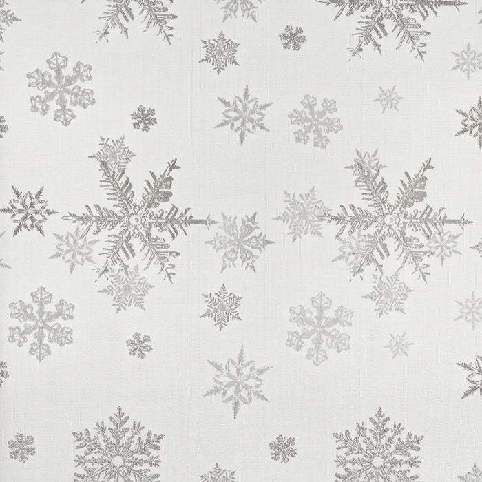 A rectangular placemat with a repeating pattern of silver snowflakes on a textured off-white background.