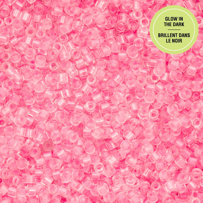 Pink glow-in-the-dark beads on a pink background with a green label.