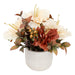 An artificial autumn floral arrangement in a textured white ceramic pot, featuring cream-colored peonies, rust-red calla lilies, and greenish-brown leaves on a white background.
