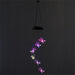 Colorful butterfly-shaped LED lights hanging against a black background