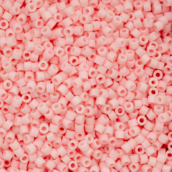 Close-up of pink plastic beads on a pink background