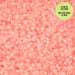Pink glow-in-the-dark beads with a green label on a pink background