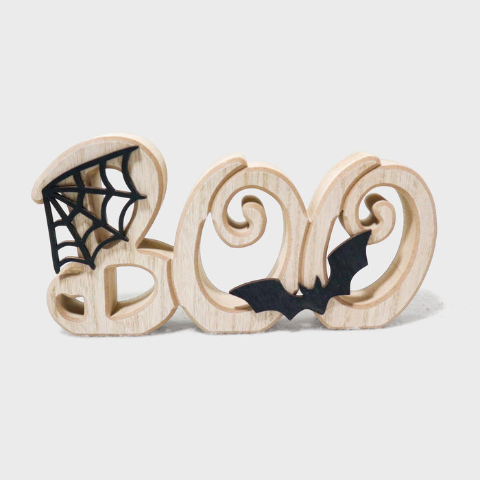 Wooden decorative letters spelling BOO with black spiderweb and bat cutout details, photographed on a light gray background.