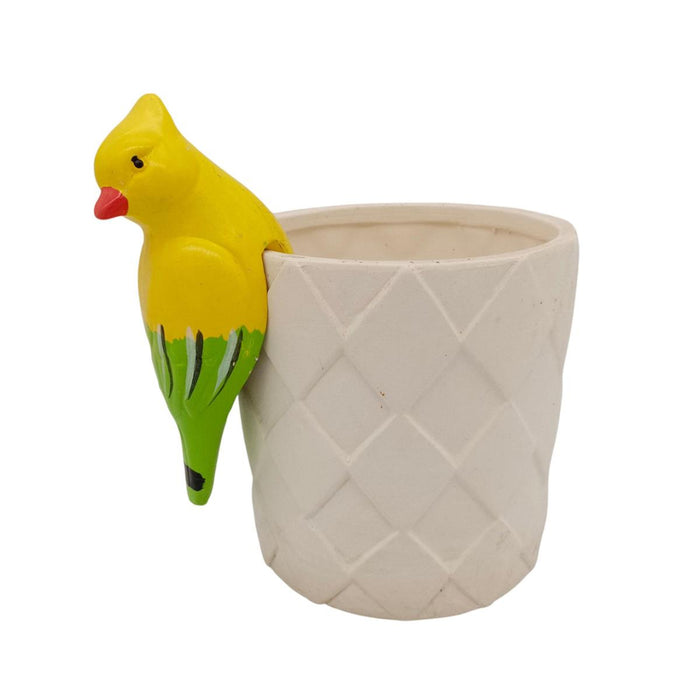Yellow bird-shaped object on a textured beige pot against a white background