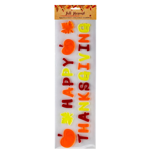 A packaged 'Fall Harvest' 'Happy Thanksgiving' foam banner decoration set, featuring orange pumpkins, yellow and red autumn leaves, and colorful lettering on a white background.