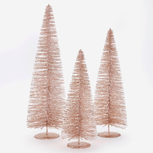 Three rose gold metallic bottle brush Christmas trees in varying heights, standing on round bases against a white background.