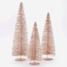 Three rose gold metallic bottle brush Christmas trees in varying heights, standing on round bases against a white background.