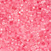 Close-up of pink plastic beads on a pink background