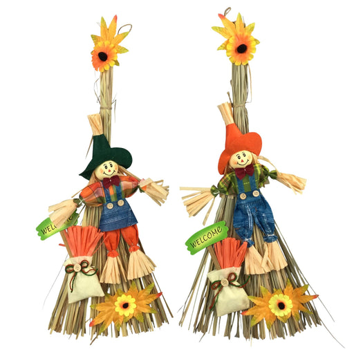 Two decorative scarecrow wall hangings on a plain white background. Each scarecrow is made from straw with a painted face, hat, overalls, and small hanging tags that read 'WELL' and 'WELCOME!'.