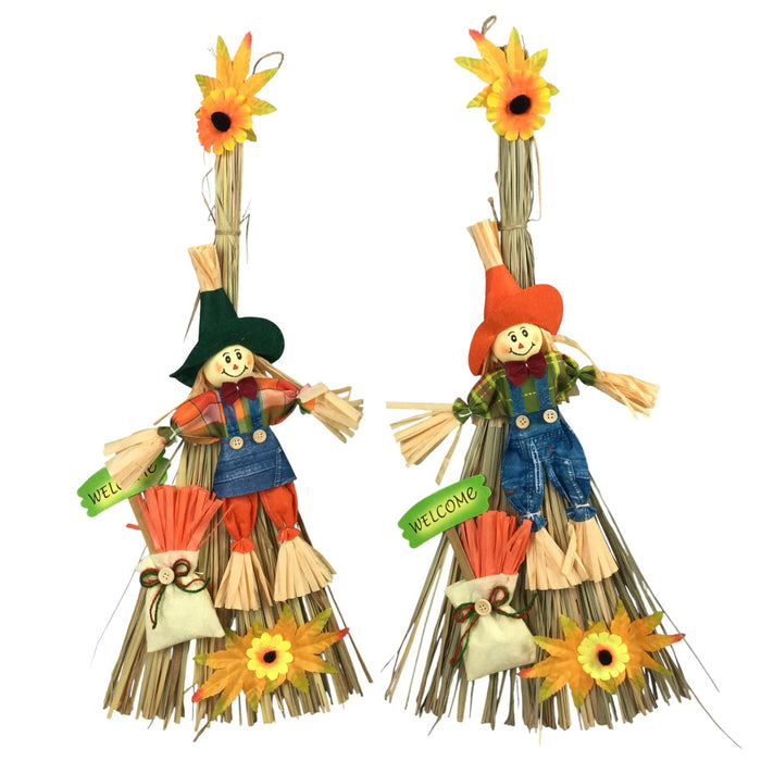 Two decorative scarecrow wall hangings on a plain white background. Each scarecrow is made from straw with a painted face, hat, overalls, and small hanging tags that read 'WELL' and 'WELCOME!'.