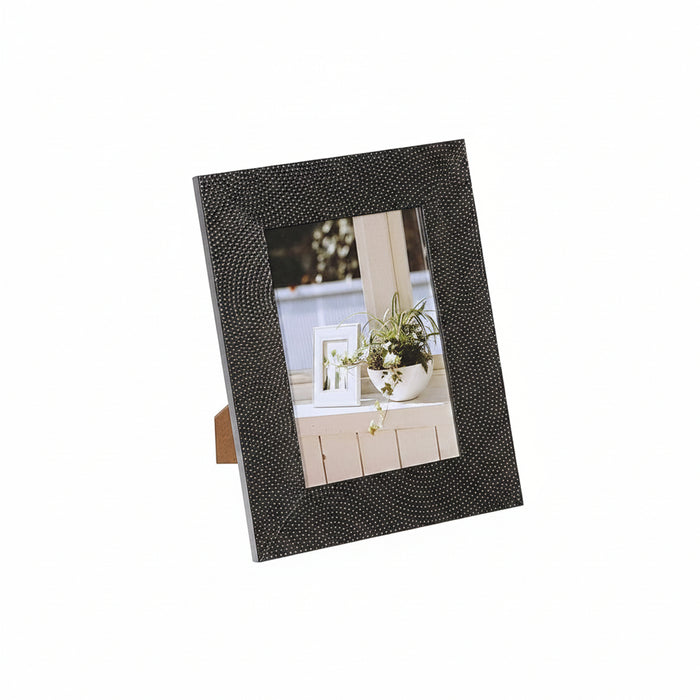 A black textured picture frame with a small dot pattern and a built-in wooden easel stand, shown on a plain white background.